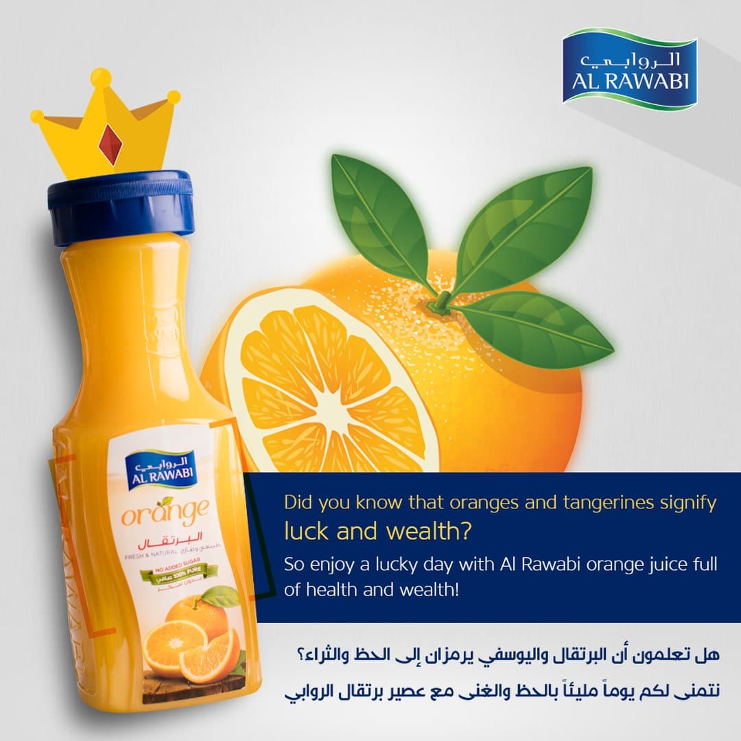 Orange juice bottle beside a crowned orange with leaves, with a bilingual caption about luck and wealth