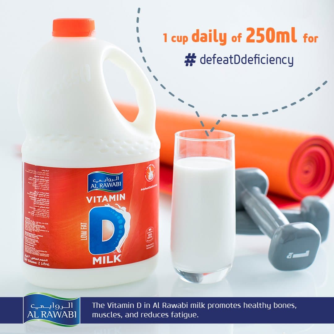 A large Vitamin D milk jug with a glass of milk, dumbbells and a yoga mat, captioned 1 cup daily of 250 ml