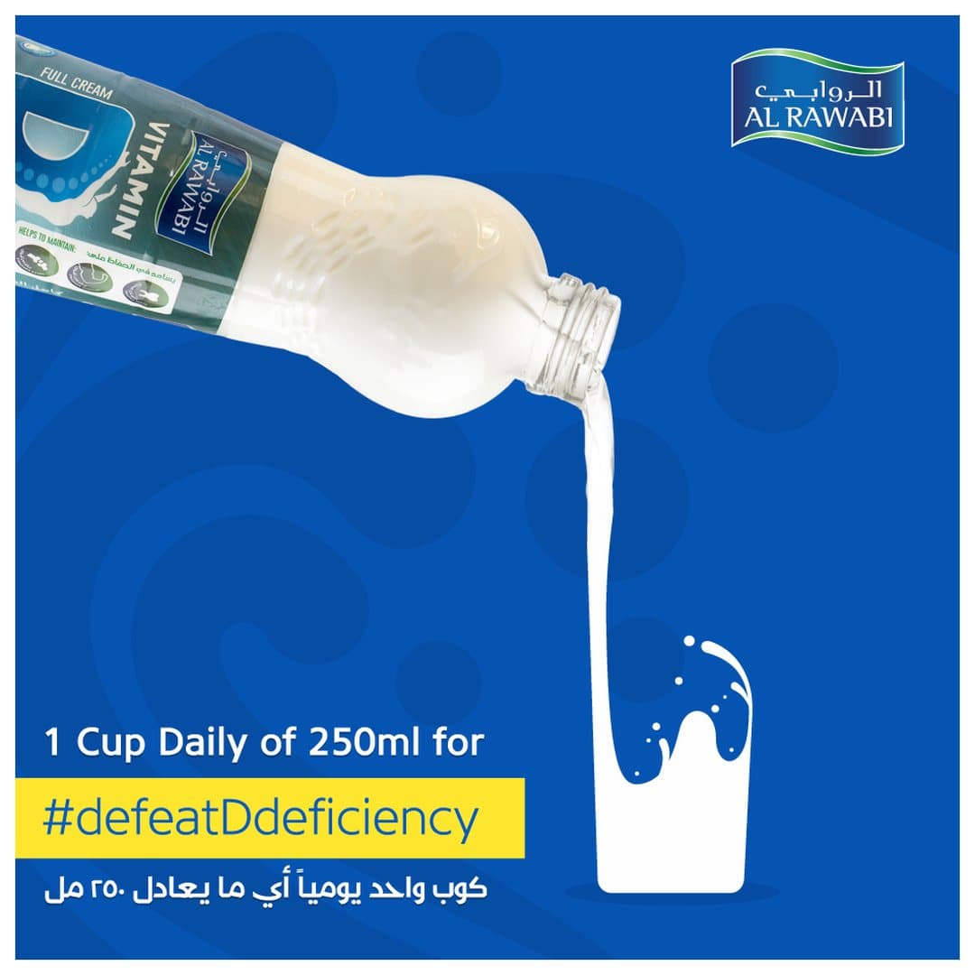 Milk pouring from a bottle into a glass on a blue background, with the hashtag defeatDdeficiency and a bilingual caption about a 250 ml daily cup
